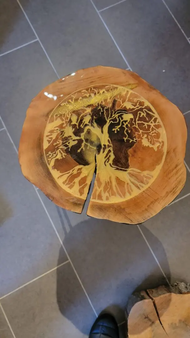 A wooden table with a leaf design on it