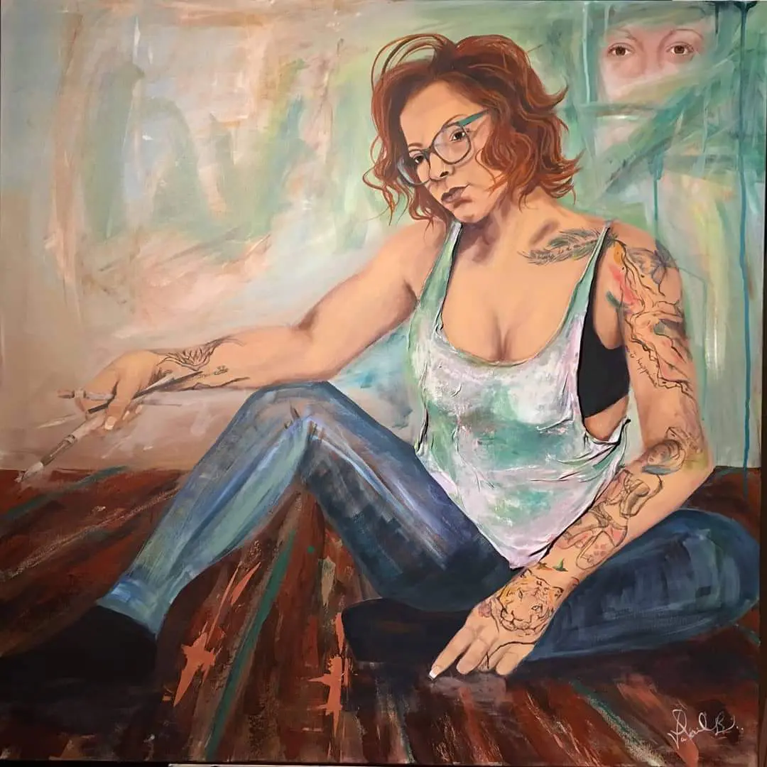 A painting of a woman with tattoos sitting on the floor.